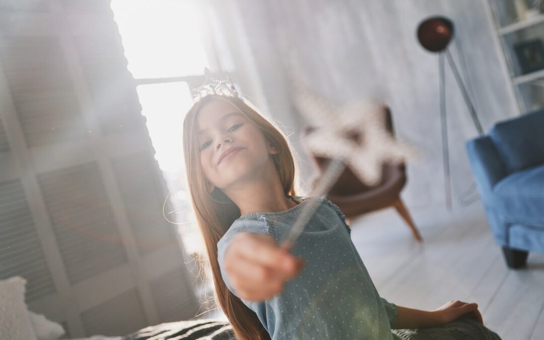 Real princess. Cute little girl playing with a magic wand while spending time at home